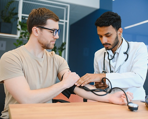 doctor checking patient blood pressure
